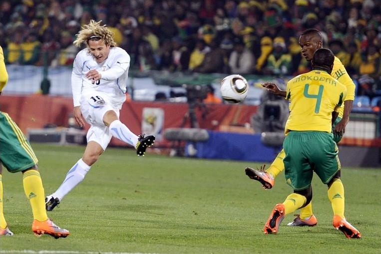 Diego Forlan scores the first of his two goals in Uruguay's 3-0 win over South Africa
