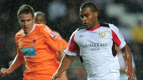 Milton Keynes Dons knocked-out Blackpool thanks to a Lewis Guy goal in extra time