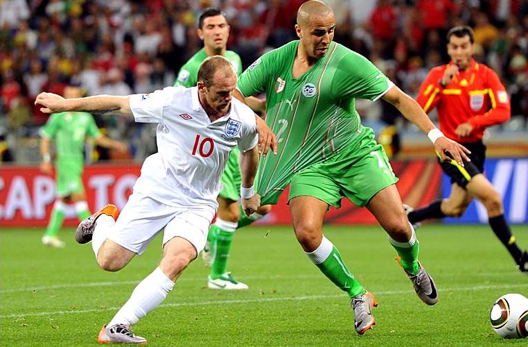 England's Wayne Rooney and Algeria's Bougherra during the 0-0 draw.