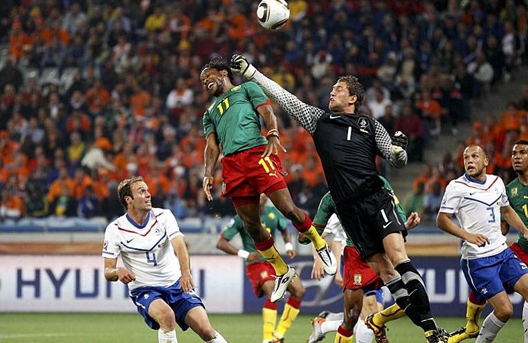 Stekelenburg of the Netherlands clears from Cameroon's Makoun in the 2-1 win for the Dutch