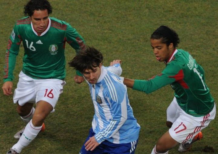 Argentina's Lionel Messi with Mexico's Giovani Dos Santos & Efrain Juarez