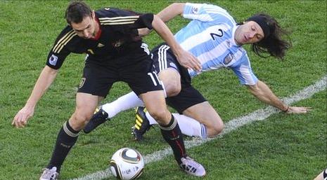 Germany's Klose and Argentina's Demichelis battle for possession in the Quarter Final
