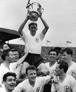 Tottenham's captain Danny Blanchflower collects the 1961 FA Cup to add to the League Championship already won that season